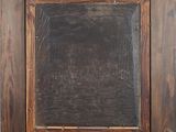 an old wooden frame with a black chalkboard in the middle