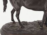 statue of a horse on a wooden base on a white background