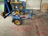 a small trailer with a fork attached to it in a garage