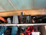 a shelf full of tools and other items in a garage