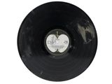 a black vinyl record with a picture of a heart on it