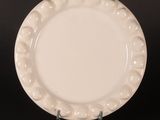 an image of a white plate sitting on top of a black table