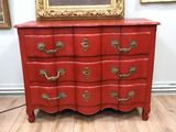 an image of a red chest of drawers in a room