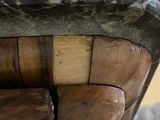 a close up of a wooden chair with a black and white design