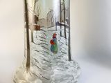 a glass vase with a picture of a person in the snow