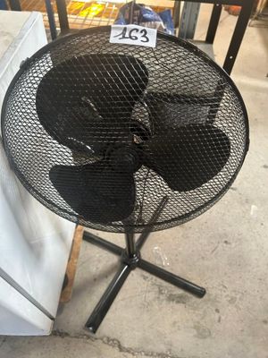 a small table with a fan on it in a store