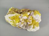 a piece of rock with yellow and white paint on it