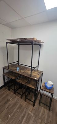 hardwood flooring in a room with a desk and a shelf