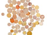 a pile of coins on a white surface