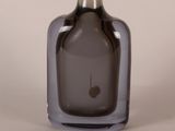 a gray glass vase with a silver top