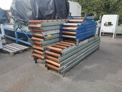 a pile of pipes on a pallet in a parking lot