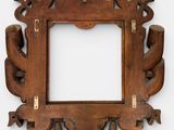 an old wooden picture frame with a decorative design on it