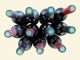 many bottles of wine stacked on top of each other