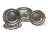 three silver plated dishes on a stand on a white surface