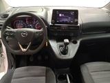 the interior of a small car with a steering wheel and dashboard controls