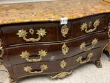 a marble top chest of drawers on display in a store