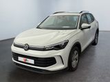 the white volkswagen suv is parked in a room with a black floor
