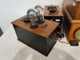 a small wooden box with a clock on top of it