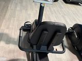 a gym room with tread machines and a monitor on the wall