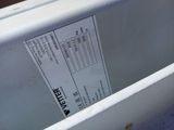 a close up of a white toilet with a label on it