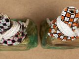 two figurines of a turtle and a turtle on a plate