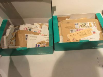 two boxes with mail inside of them on a table