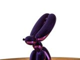 a purple balloon shaped like a bunny sitting on a table