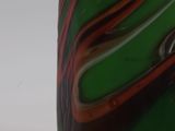 a close up view of a green and red vase