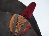 a close up of a horse ' s head with a red hat on it
