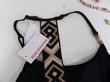 black bikini with gold and black geometric design on the back of the bra