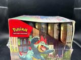 a close up of a box of pokemon toys on a black surface