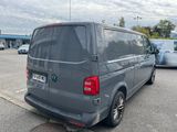 a grey van that is parked in a parking lot