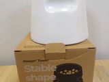 a white bowl on top of a cardboard box on a table