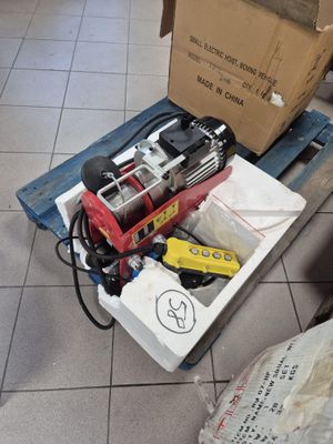 a box of tools sitting on the floor next to a cardboard box