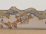 a close up of a glass bowl with flowers on it