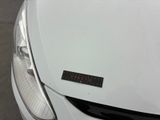 a sticker on the hood of a white car