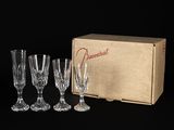 un lot de quatre verres à vin en cristal présentés dans une boîte en carton