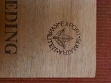 a close up of a wooden box with a logo on it