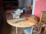 a wooden table and chairs in a room with a red wall