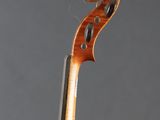 an old violin with a long neck and a long bow