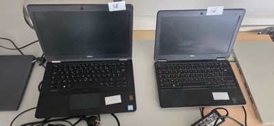 two laptops that are sitting on a table