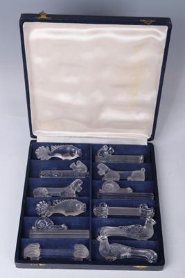 a box with a set of silverware in it on a white surface