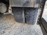a close up of a truck tire on a gravel road