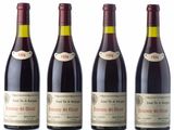 four bottles of wine are lined up on a white surface