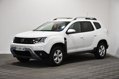 the white dacia is parked in a room with a checkered floor