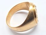 an image of a close up of a gold ring on a white surface