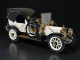 a small model of a car on a black surface