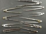 six pairs of surgical instruments sitting on top of a table