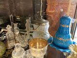 many glass vases and other glass items on the table