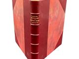 an old red book with a gold binding on a white background